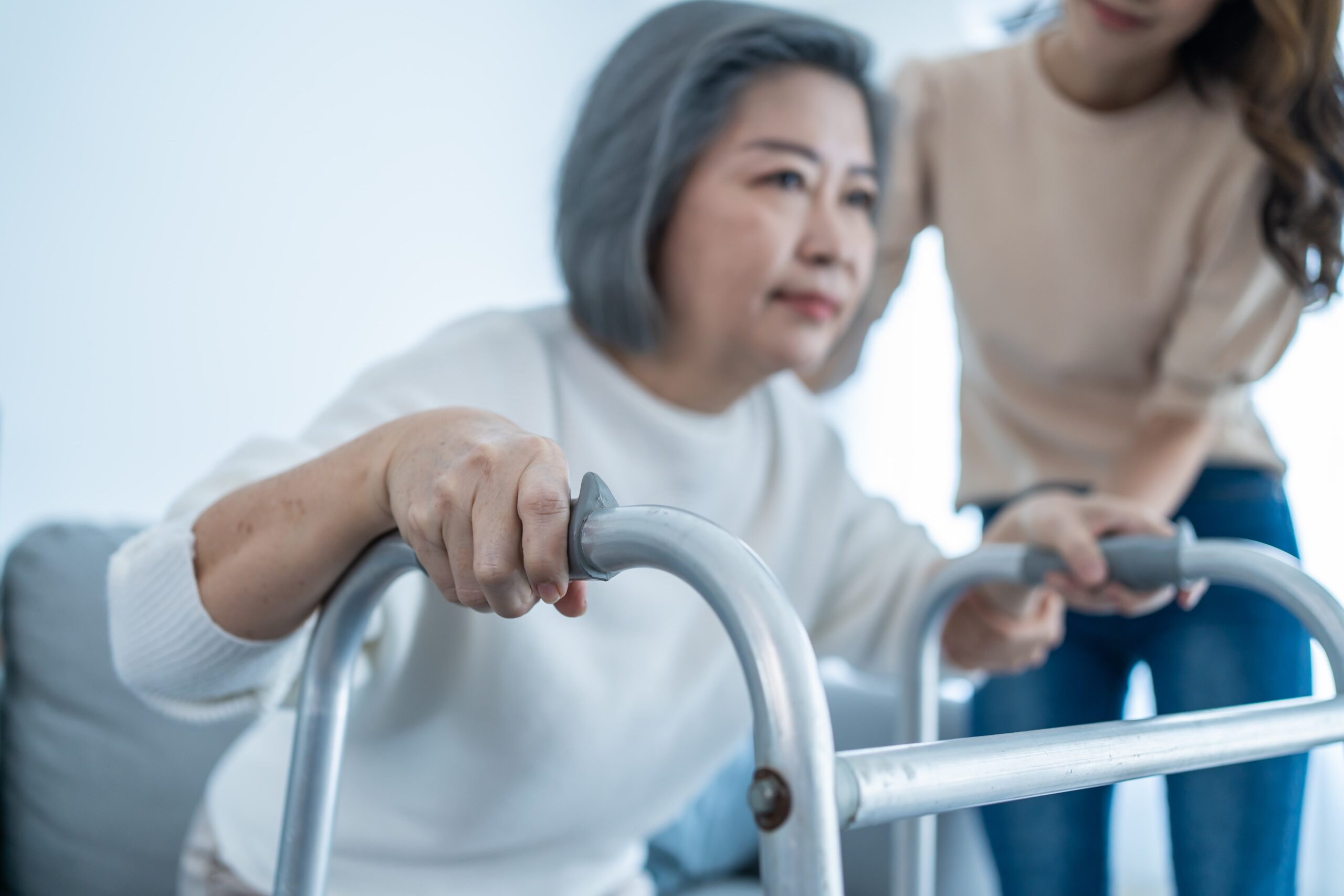 Girl helping women with walker