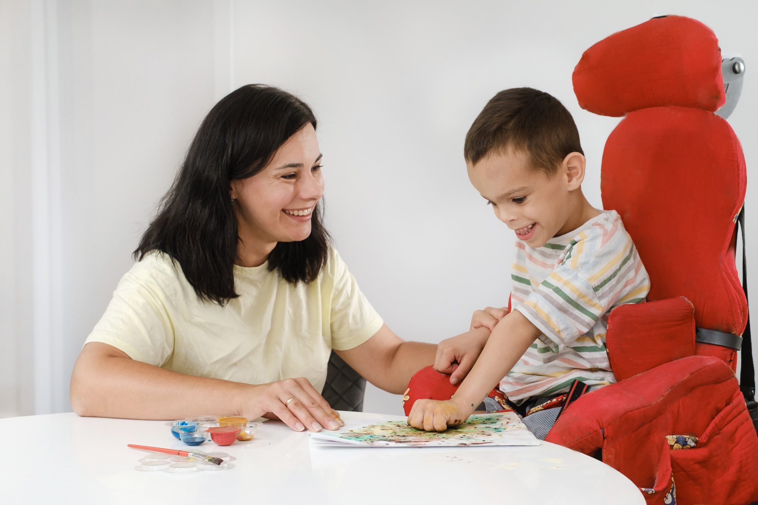 Women helping child paint