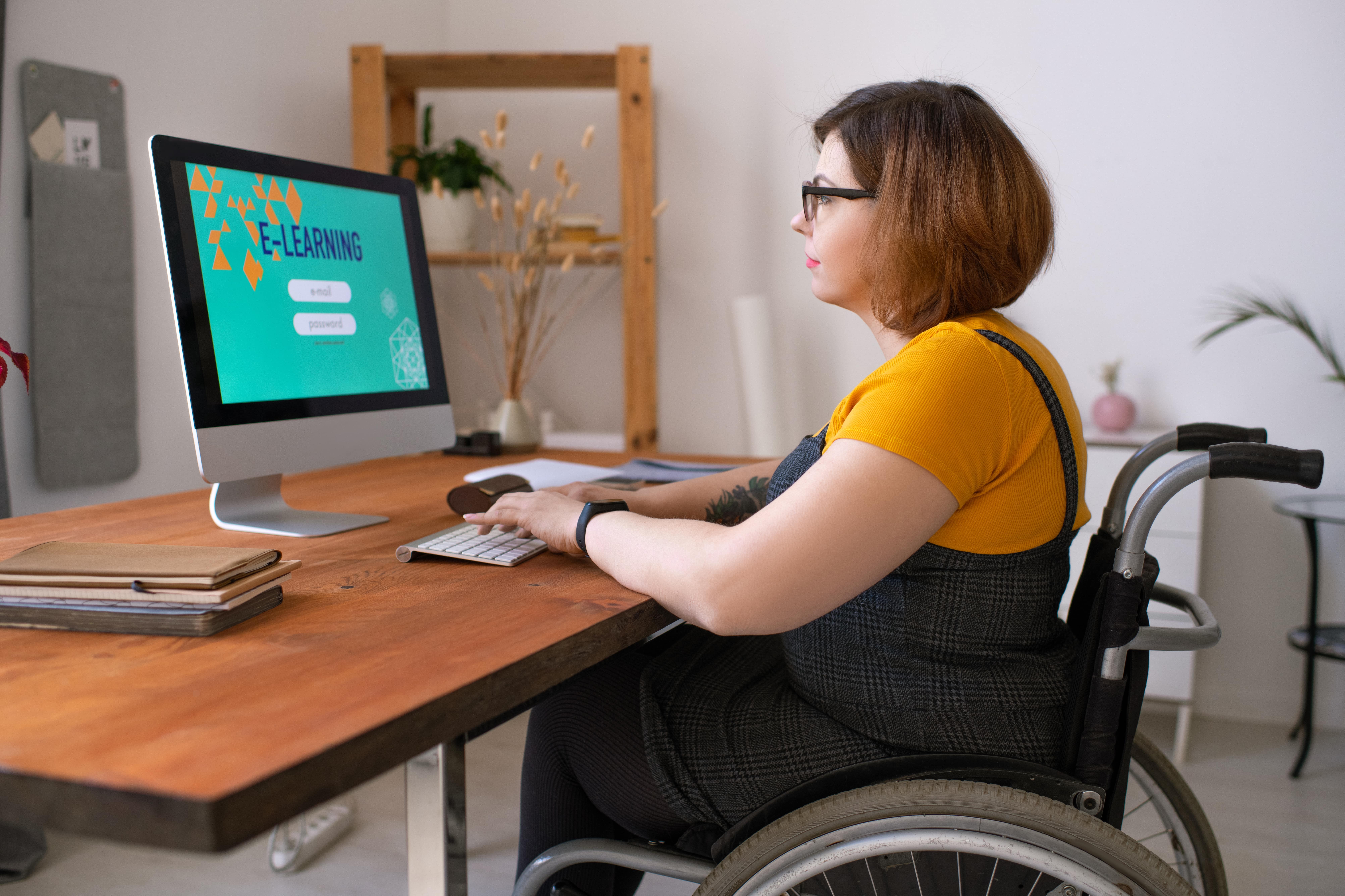 Woman in wheelchair on computer