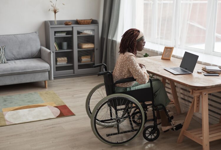 Woman in wheelchair at her desk