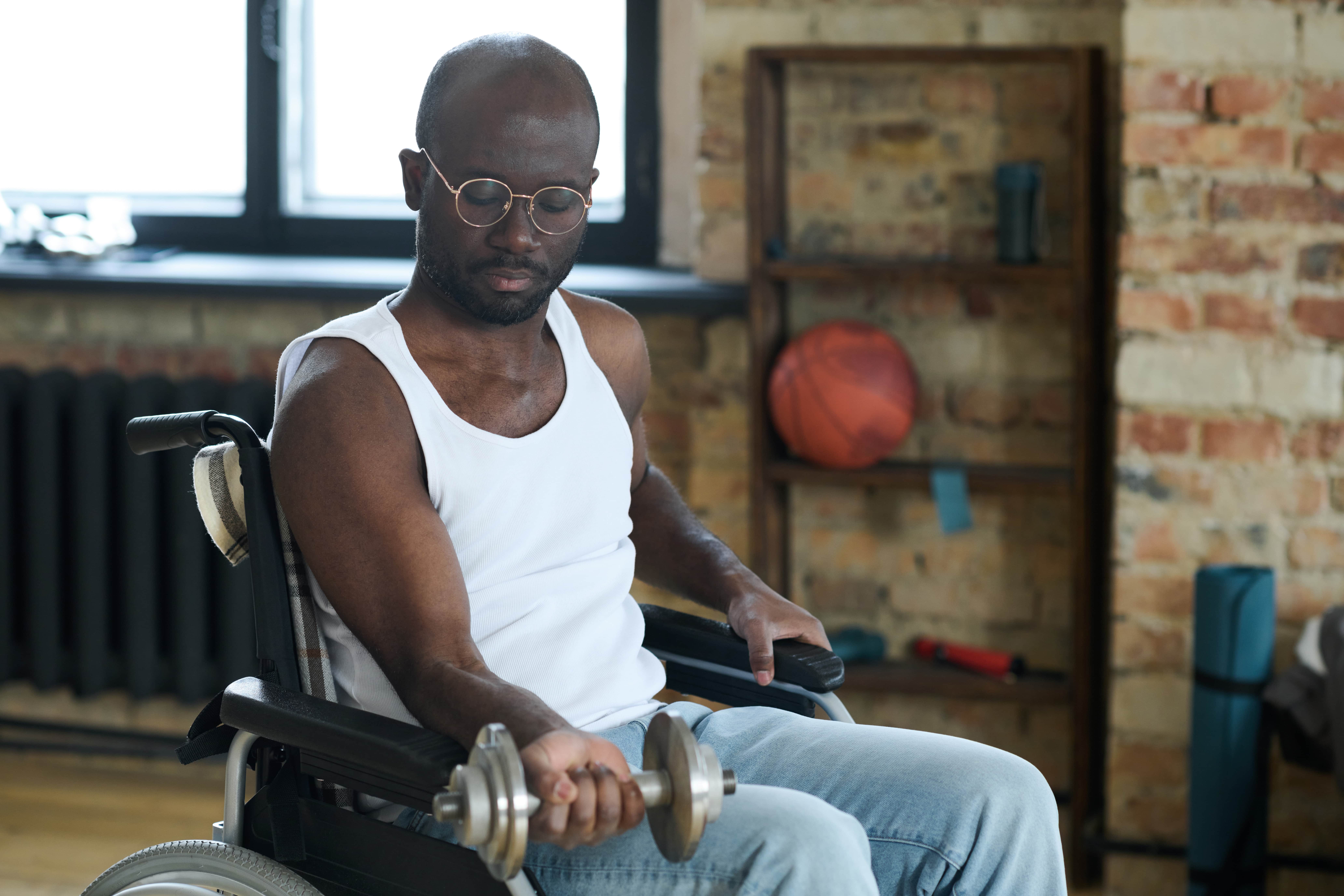 Man in wheelchair lifting weights