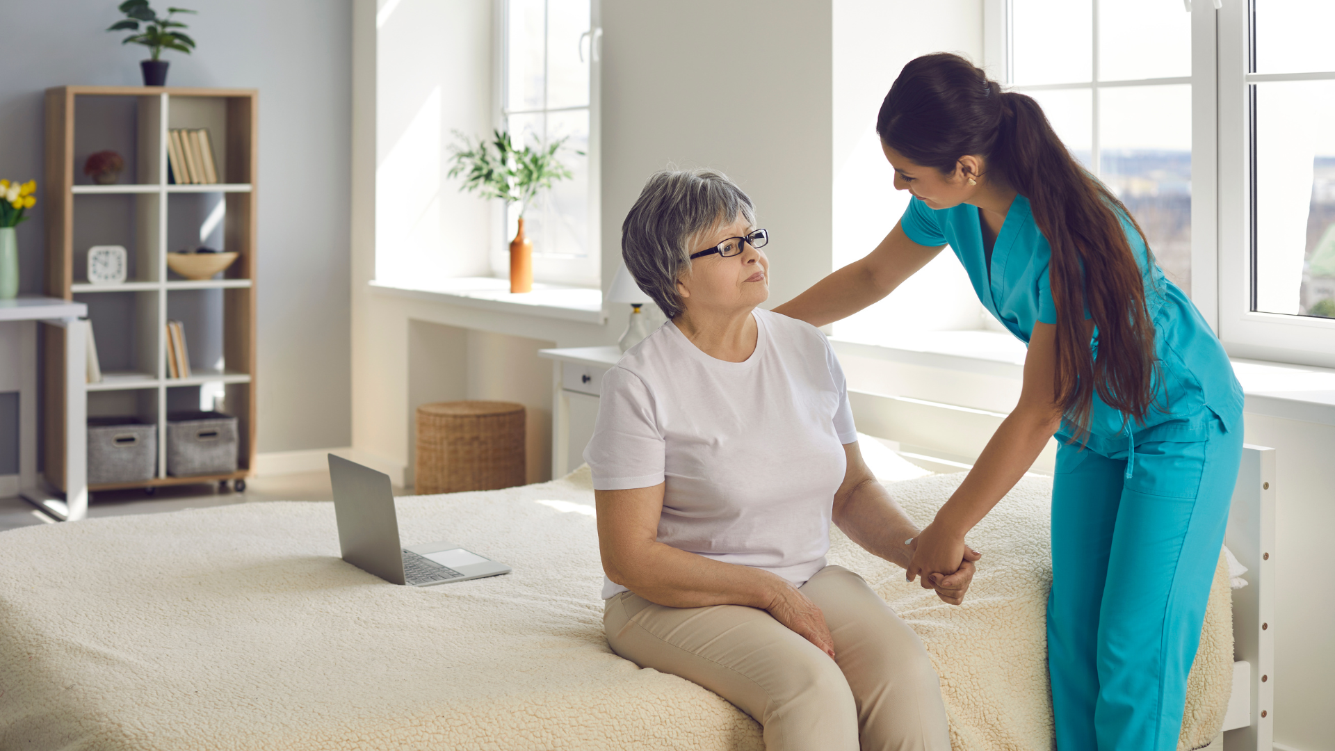 Nurse helping women onto bed