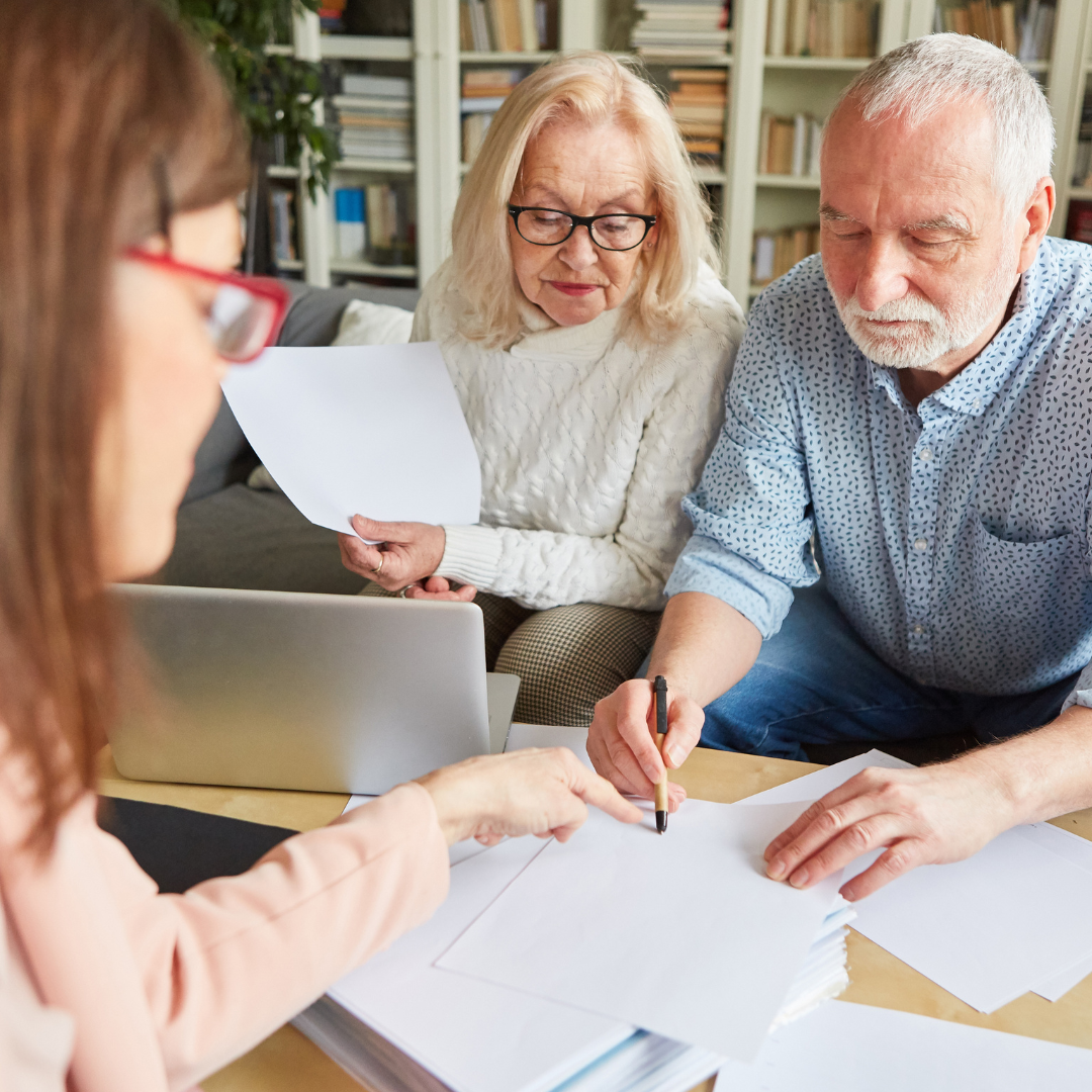 3 people going over documents at a table